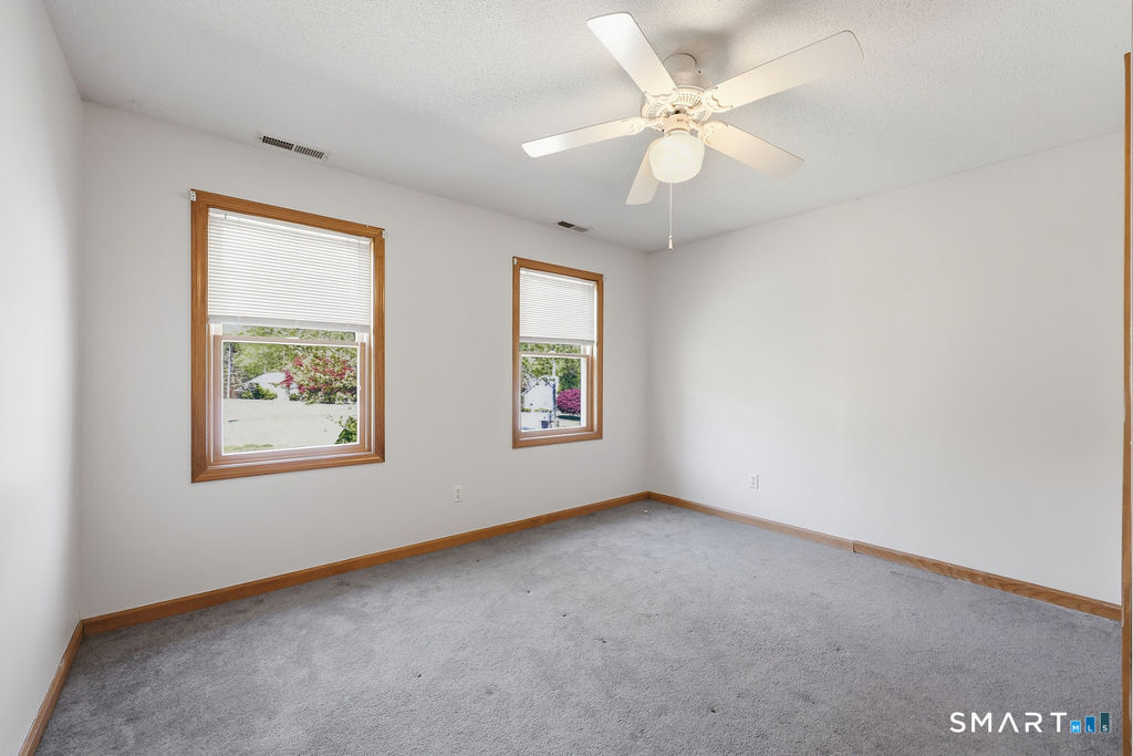 12 Forest Ridge Road Prospect, CT 06712 - Photo 16 of 40 an empty room with windows and fan
