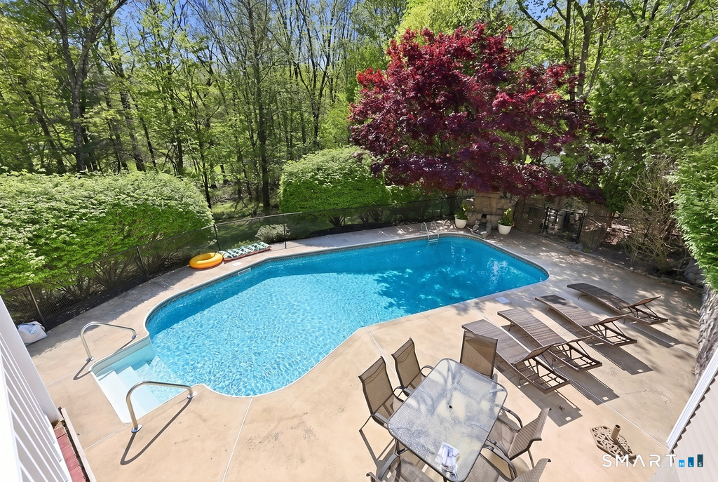 12 Forest Ridge Road Prospect, CT 06712 - Photo 36 of 40 a view of a swimming pool with lawn chairs under an umbrella