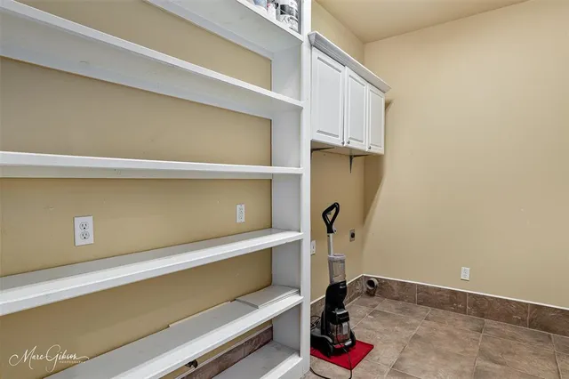 a view of storage and utility room with closet dryer and washer