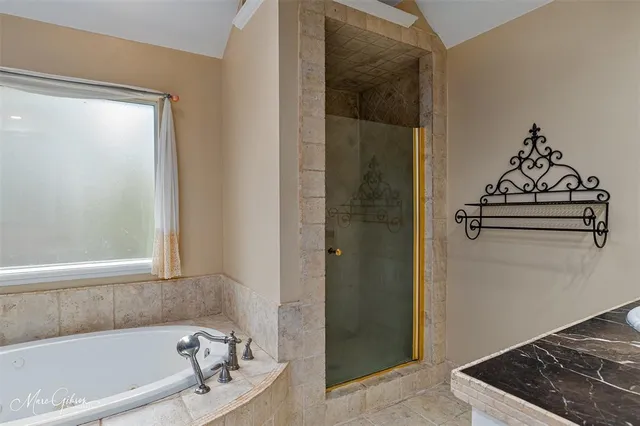 a bathroom with a bathtub and shower