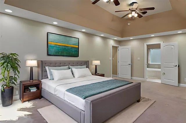 a spacious bedroom with a bed and a ceiling fan