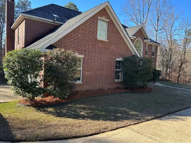 a front view of a house with garden