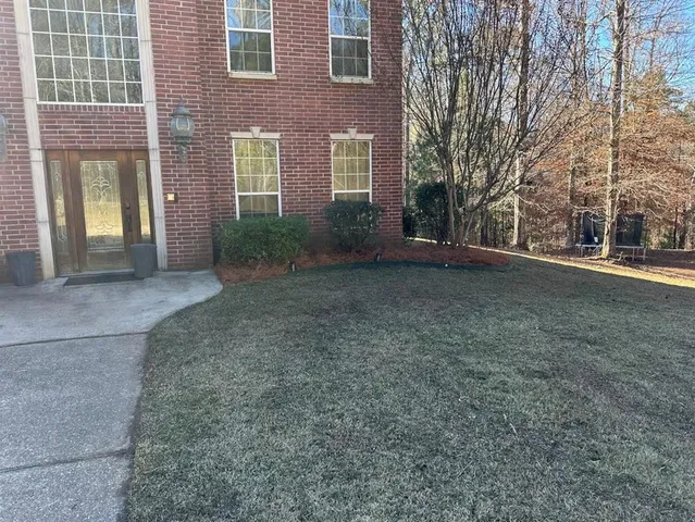 a front view of a house with a yard