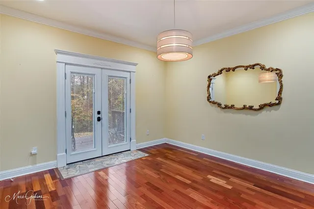 a view of a livingroom with wooden floor and a sink