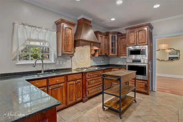 a kitchen with stainless steel appliances granite countertop sink stove and microwave