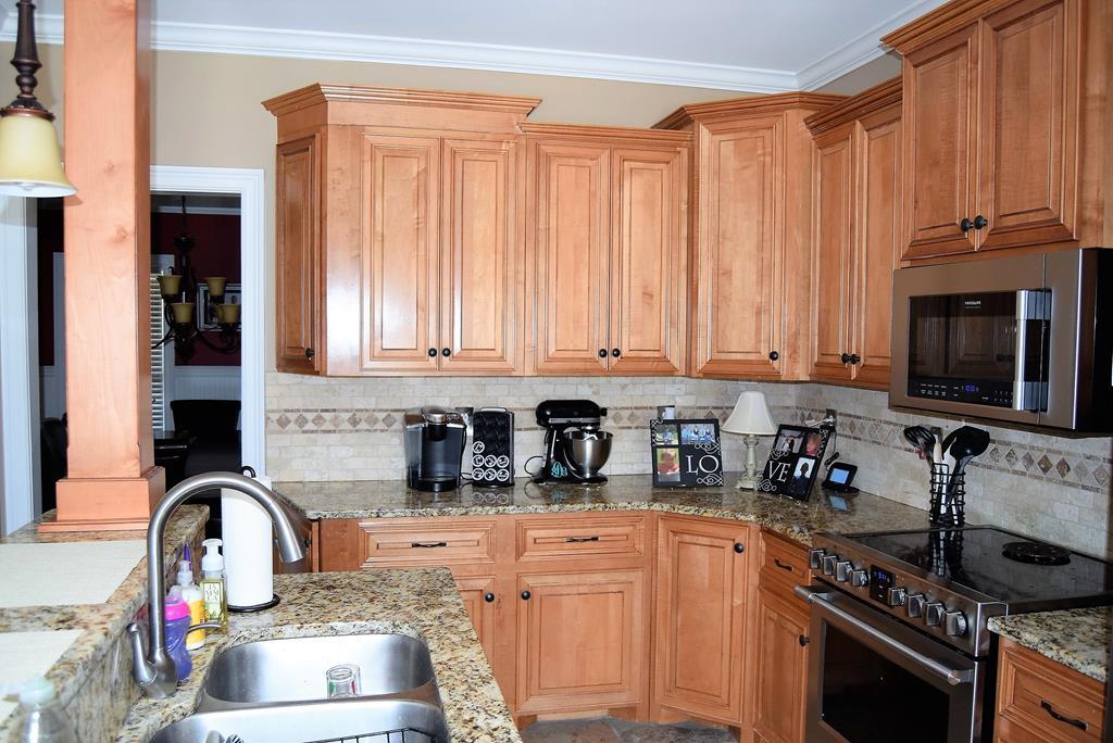 781 McKay Road Gray, GA 31032 - Photo 13 of 36 a kitchen with stainless steel appliances granite countertop a stove a sink and a microwave