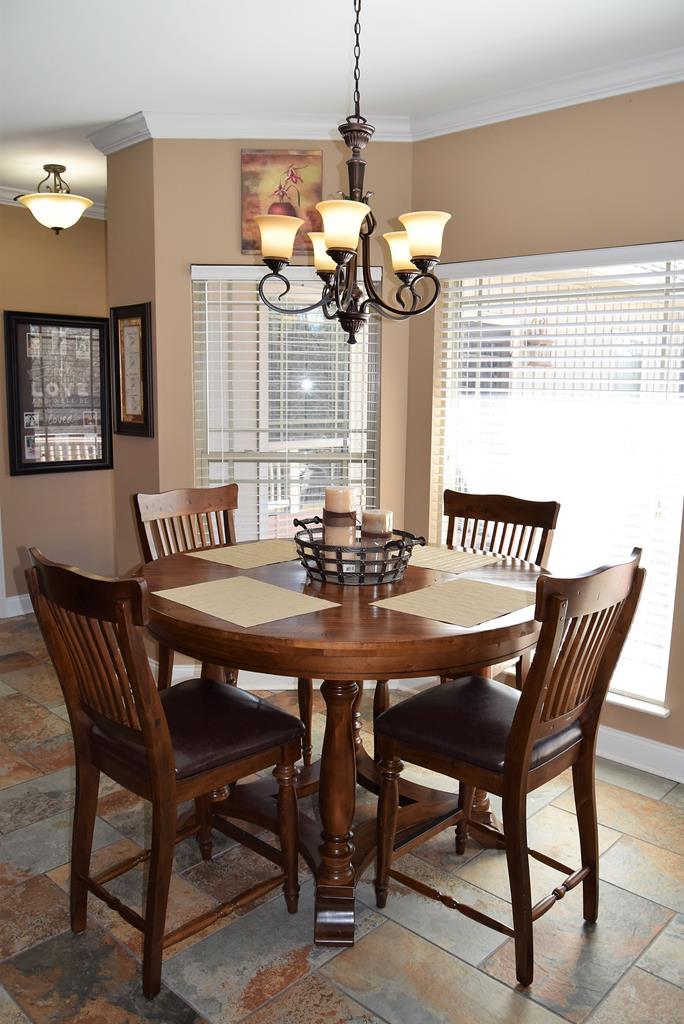 781 McKay Road Gray, GA 31032 - Photo 16 of 36 a dining room with furniture a chandelier and window