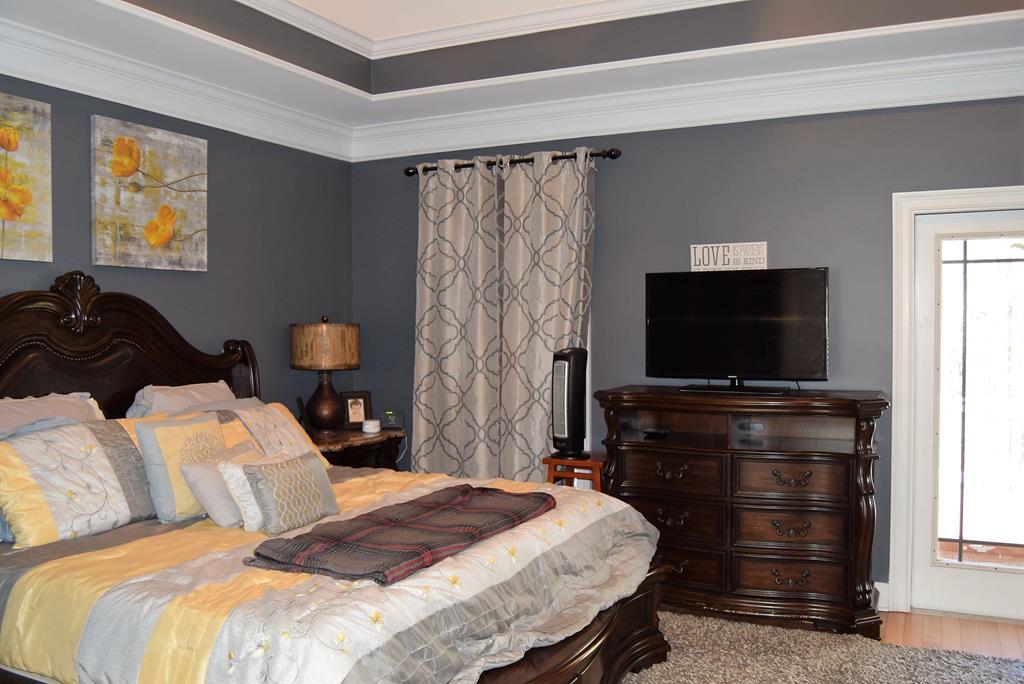 781 McKay Road Gray, GA 31032 - Photo 19 of 36 a bedroom with a bed and a flat screen tv