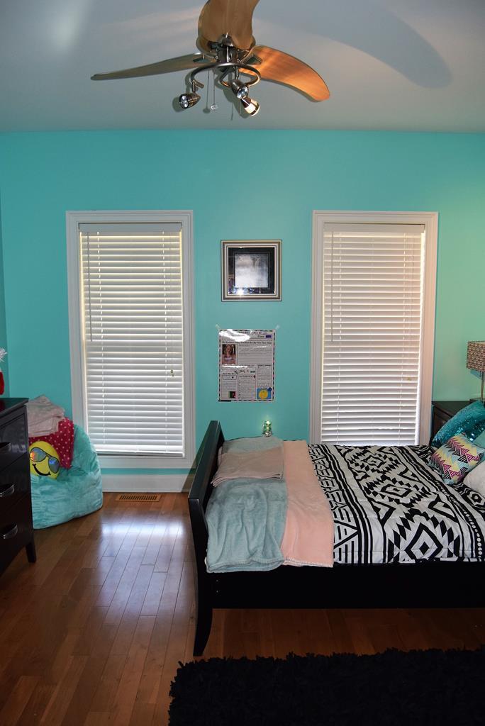 781 McKay Road Gray, GA 31032 - Photo 24 of 36 a bedroom with a bed and wooden floor