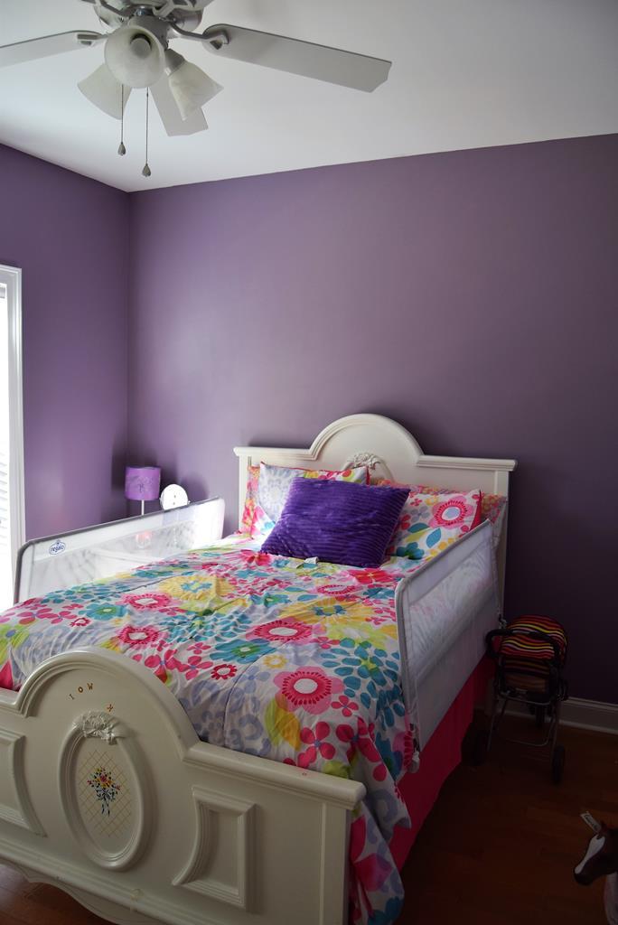 781 McKay Road Gray, GA 31032 - Photo 25 of 36 a bedroom with a bed and a chandelier