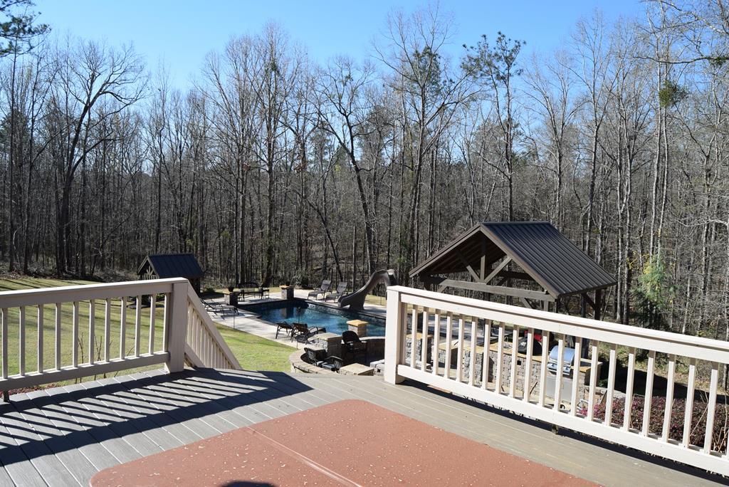 781 McKay Road Gray, GA 31032 - Photo 29 of 36 a view of a roof deck with wooden fence and trees