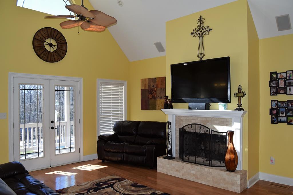 781 McKay Road Gray, GA 31032 - Photo 9 of 36 a living room with a fireplace and a flat screen tv