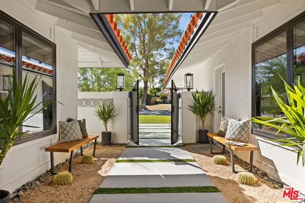 a front view of house with yard slide and seating