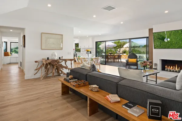 a living room with fireplace furniture and a flat screen tv