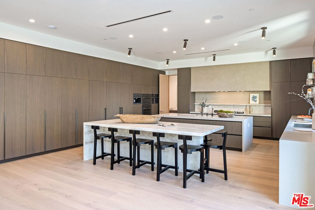 17055 Rancho Street Encino, CA 91316 - Photo 36 of 73 a kitchen with a table and chairs in it