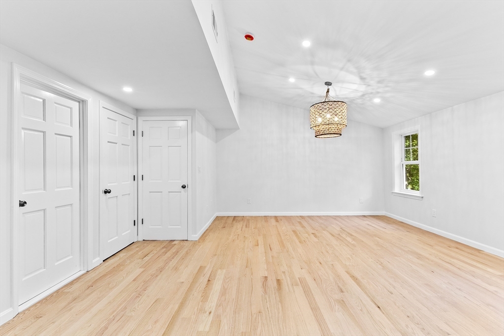22 Clifford Court Hingham, MA 02043 - Photo 16 of 26 a view of empty room with wooden floor and fan