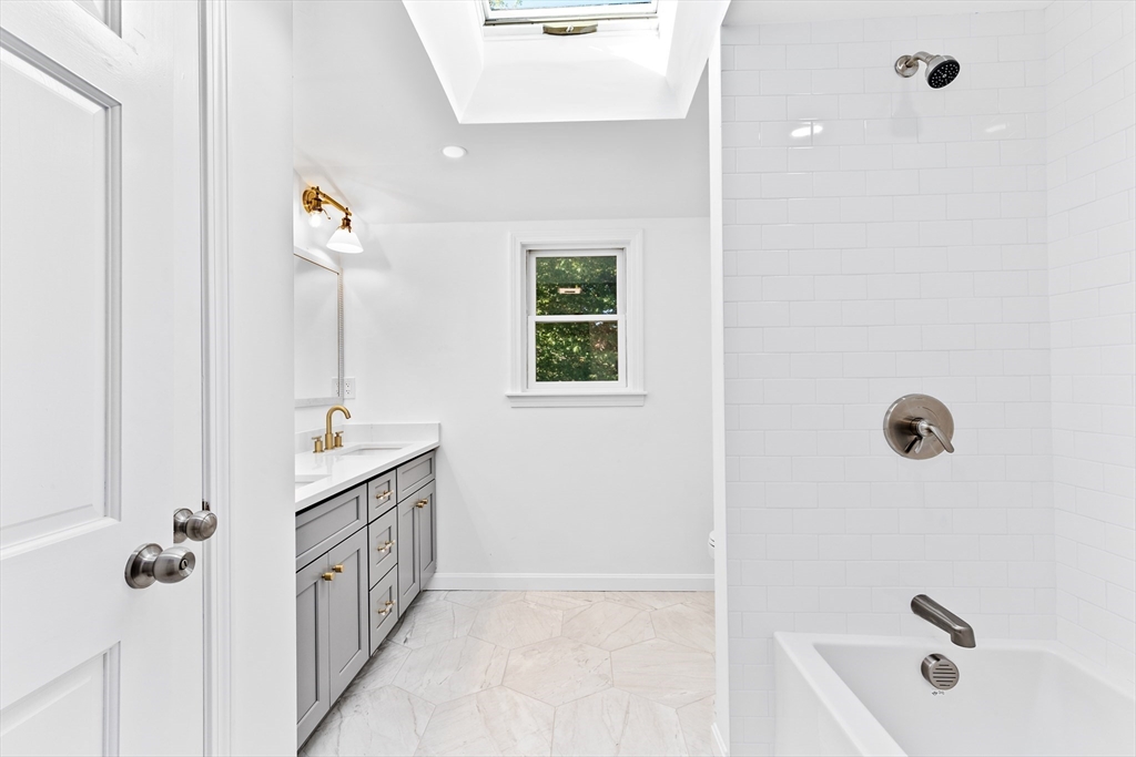 22 Clifford Court Hingham, MA 02043 - Photo 19 of 26 a bathroom with a tub sink a mirror and shower