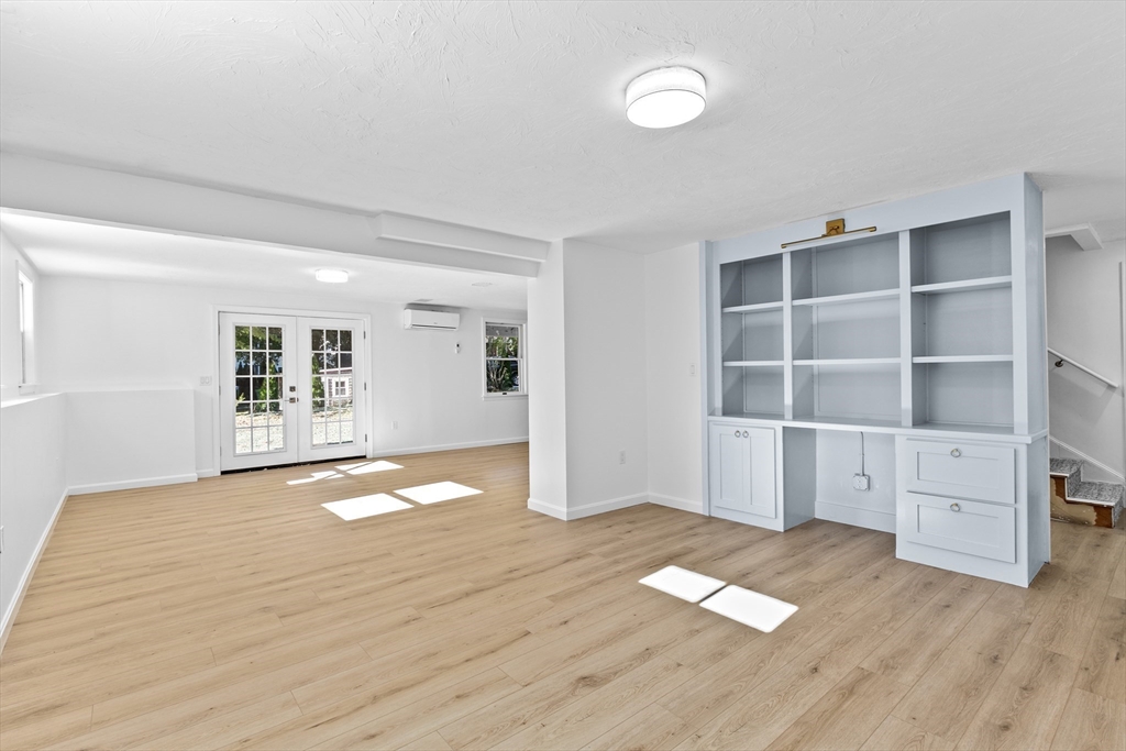 22 Clifford Court Hingham, MA 02043 - Photo 20 of 26 a view of empty room with wooden floor and window