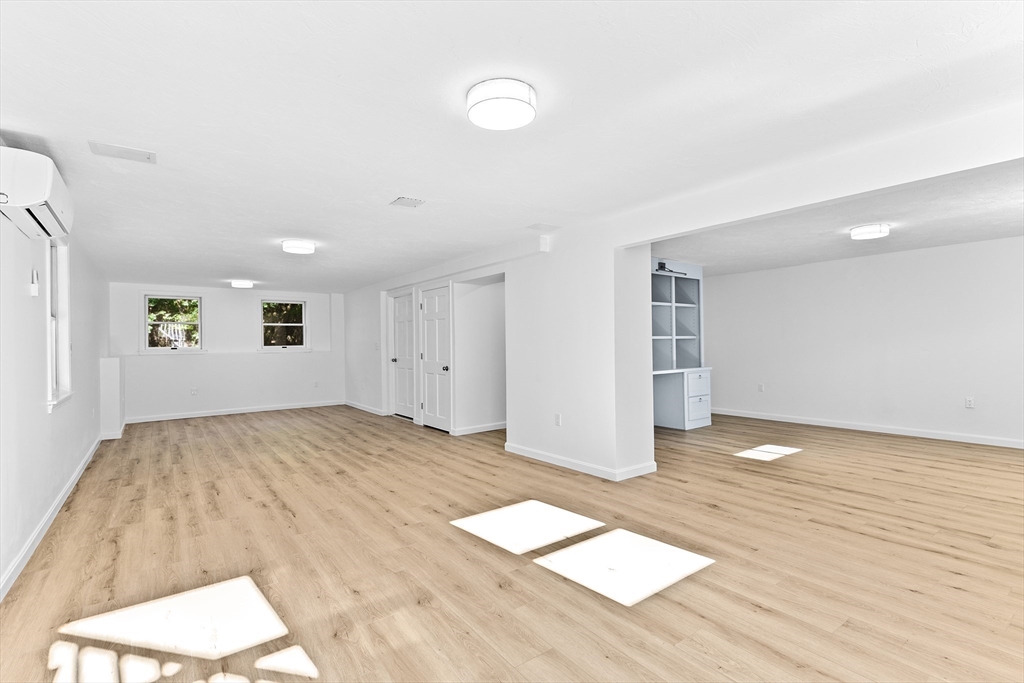 22 Clifford Court Hingham, MA 02043 - Photo 22 of 26 a view of empty room with wooden floor and fan