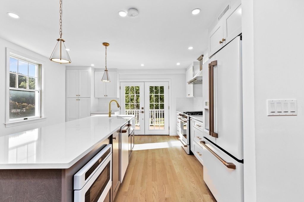 22 Clifford Court Hingham, MA 02043 - Photo 5 of 26 a open kitchen with a refrigerator a sink and cabinets