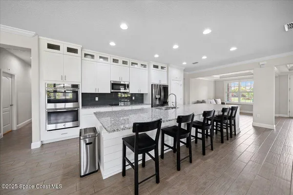 a kitchen with stainless steel appliances granite countertop counter top space and wooden floor