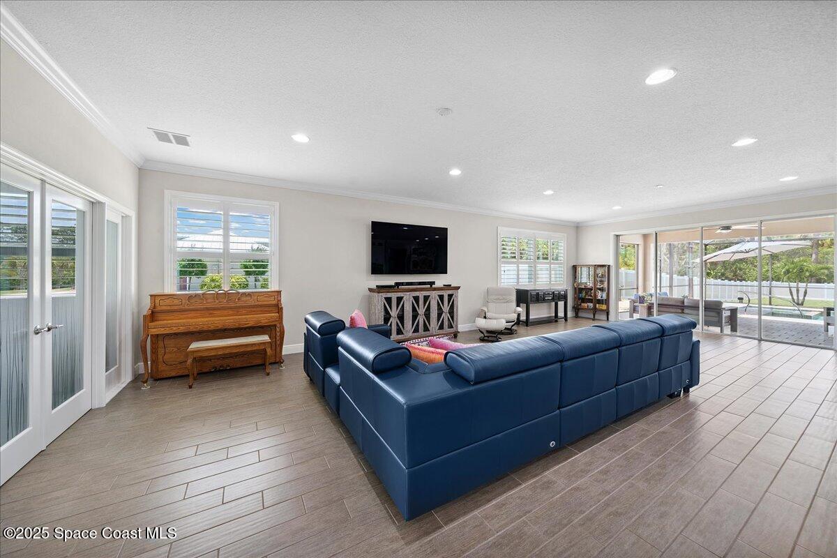 4357 Preservation Circle Melbourne, FL 32934 - Photo 14 of 56 a living room with furniture and a flat screen tv