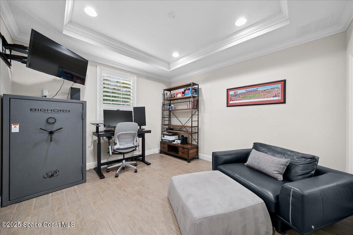 4357 Preservation Circle Melbourne, FL 32934 - Photo 17 of 56 a bedroom with furniture and a flat screen tv