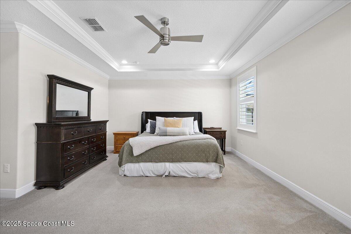 4357 Preservation Circle Melbourne, FL 32934 - Photo 20 of 56 a bedroom with a bed and a tv