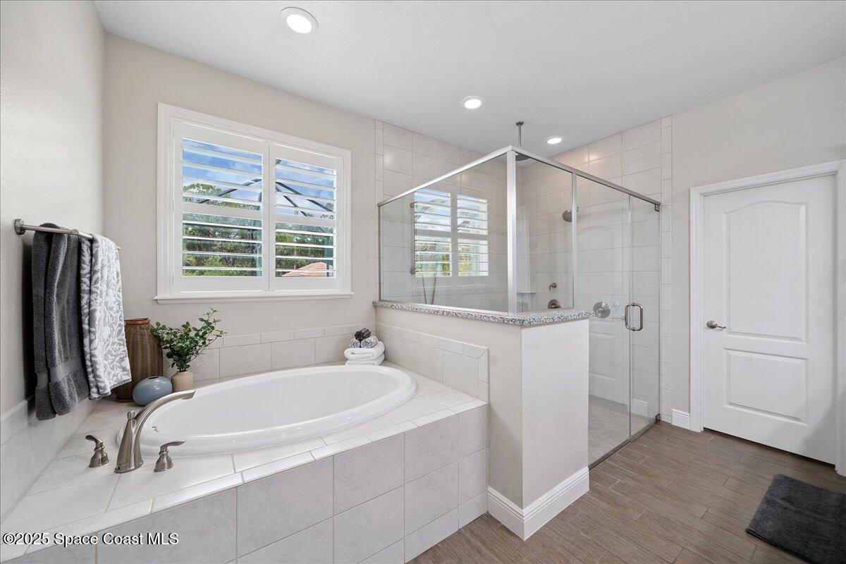 4357 Preservation Circle Melbourne, FL 32934 - Photo 21 of 56 a bathroom with a tub sink and mirror