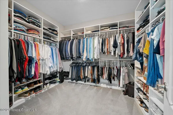 a spacious bedroom with a bed and a window