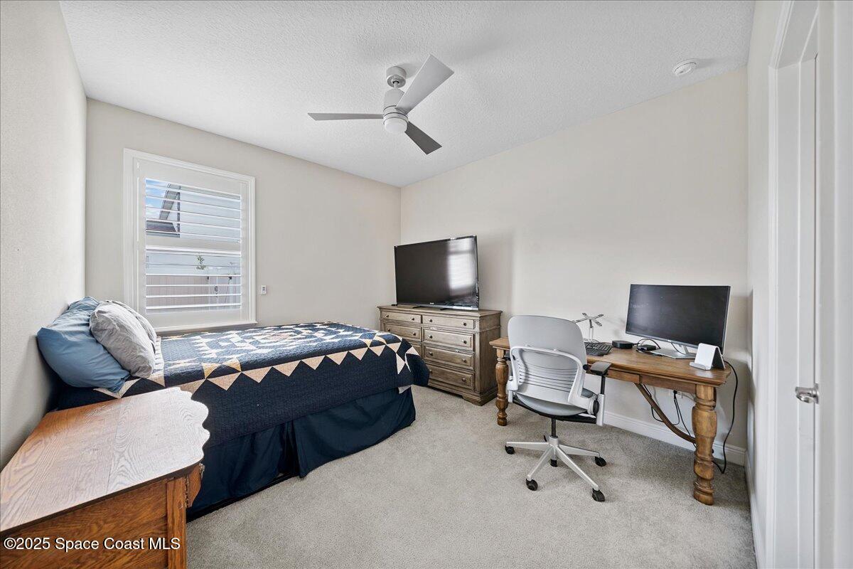4357 Preservation Circle Melbourne, FL 32934 - Photo 26 of 56 a bedroom with a workspace