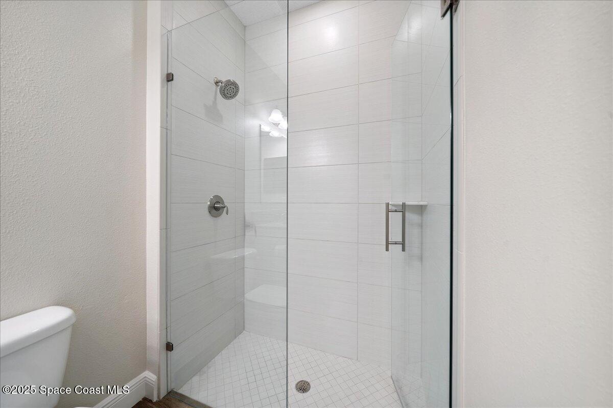 4357 Preservation Circle Melbourne, FL 32934 - Photo 28 of 56 a bathroom with a shower and toilet