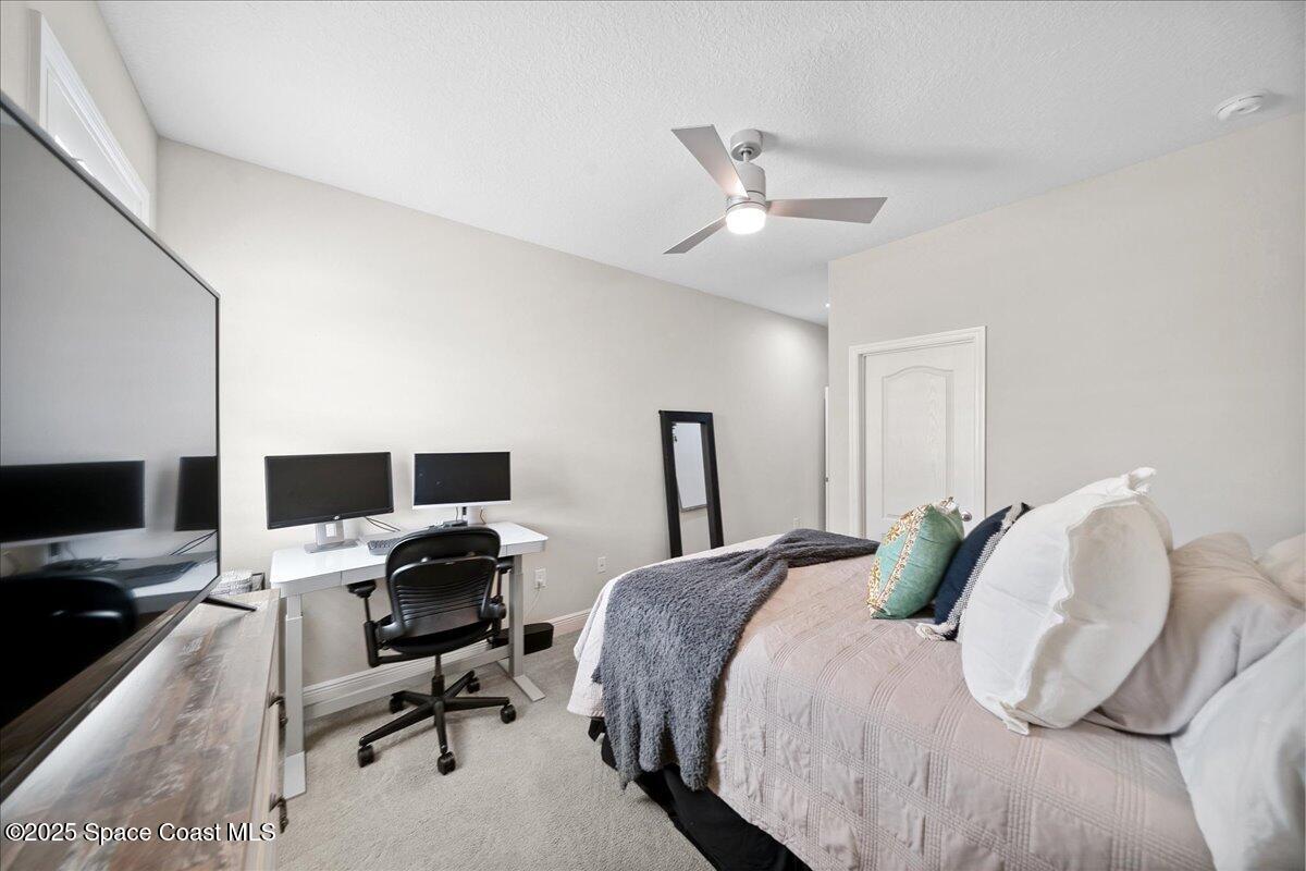 4357 Preservation Circle Melbourne, FL 32934 - Photo 31 of 56 a bedroom with a bed and a flat screen tv