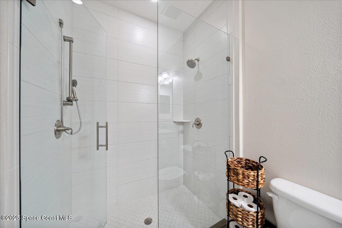 4357 Preservation Circle Melbourne, FL 32934 - Photo 33 of 56 a bathroom with a shower and a toilet