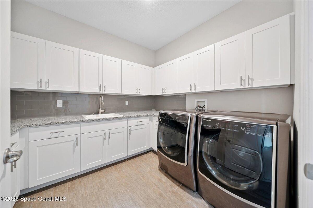 4357 Preservation Circle Melbourne, FL 32934 - Photo 36 of 56 a kitchen with granite countertop white cabinets and stainless steel appliances