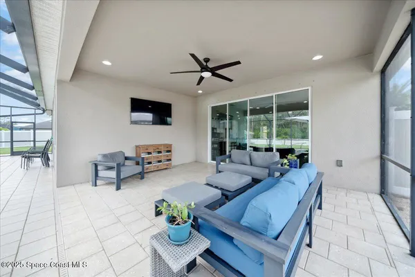a view of a terrace with furniture and a yard