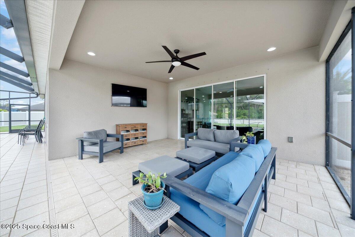 4357 Preservation Circle Melbourne, FL 32934 - Photo 38 of 56 a living room with furniture and a flat screen tv
