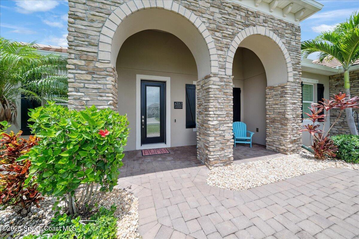 4357 Preservation Circle Melbourne, FL 32934 - Photo 7 of 56 a front view of a house with plants