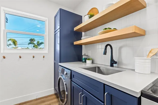 a living room with furniture flowerpot and wooden floor