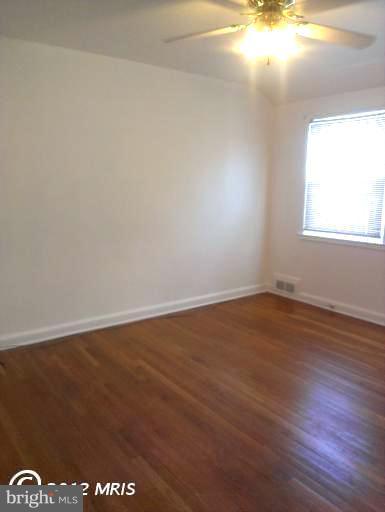 1615 Ramblewood Road Baltimore, MD 21239 - Photo 11 of 19 a view of an empty room and window