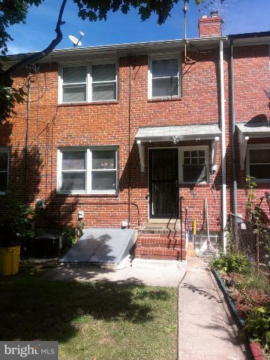 1615 Ramblewood Road Baltimore, MD 21239 - Photo 14 of 19 a front view of a house with a yard