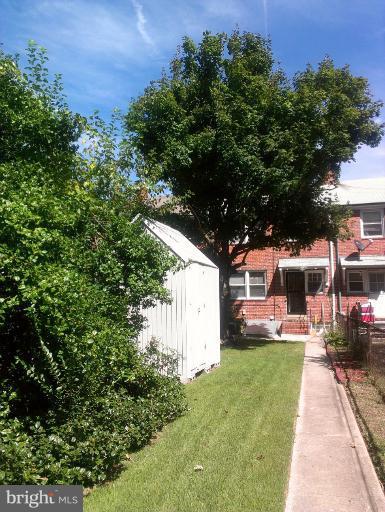1615 Ramblewood Road Baltimore, MD 21239 - Photo 16 of 19 a view of a yard with plants and a fountain