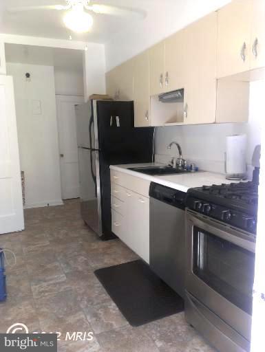1615 Ramblewood Road Baltimore, MD 21239 - Photo 5 of 19 a kitchen with stainless steel appliances granite countertop a stove a refrigerator and a sink