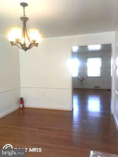 1615 Ramblewood Road Baltimore, MD 21239 - Photo 6 of 19 a view of a room with wooden floor and window