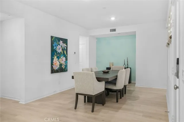 a bedroom with a bed and a potted plant