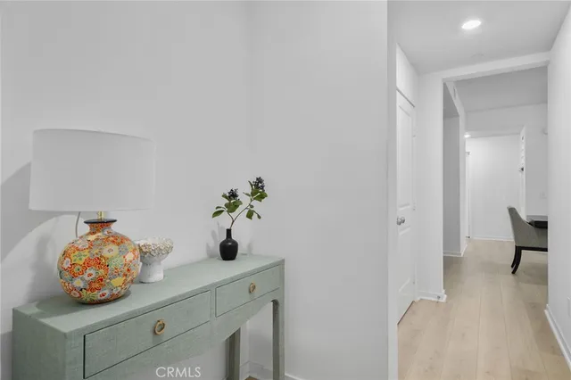 a bedroom with a bed and a potted plant