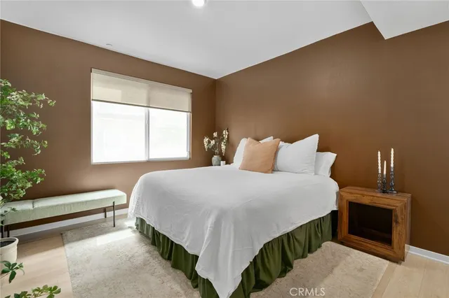 a bedroom with a bed and a large window