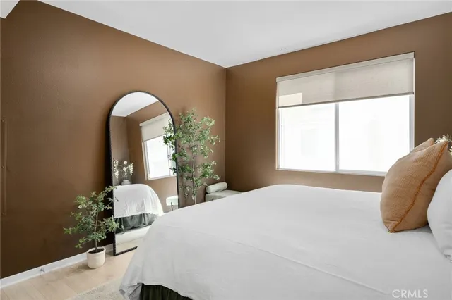 a bathroom with a toilet and a potted plant