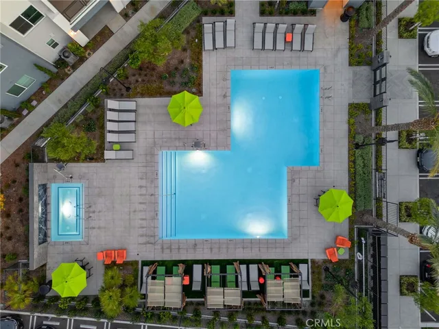 a view of a patio with table and chairs potted plants and palm tree