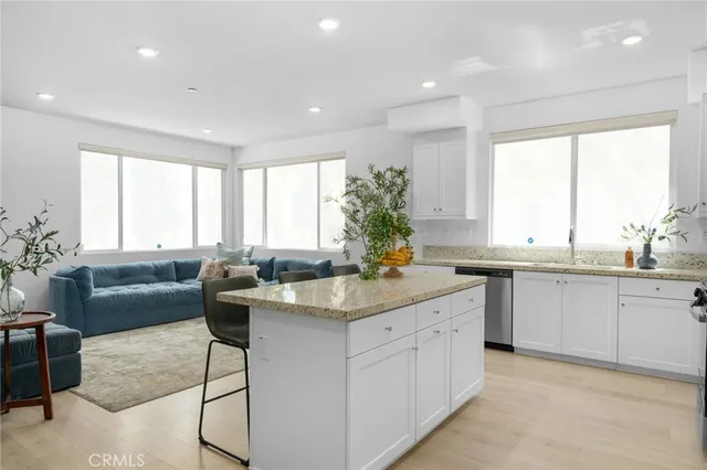 a living room kitchen with a couch and a stove top oven